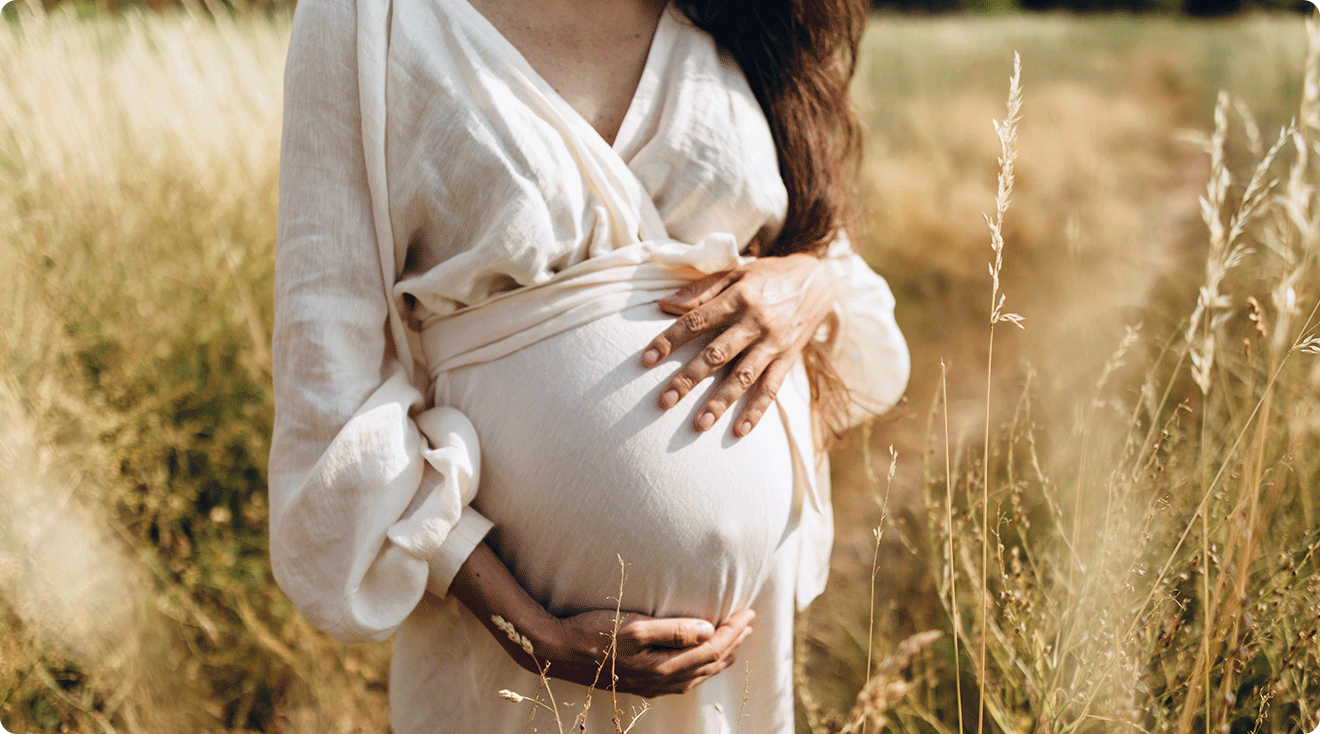 pregnant woman in tall grass field