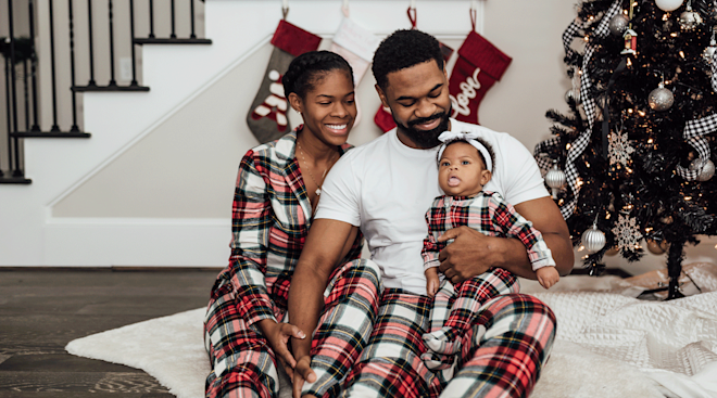 parents with their newborn baby on christmas