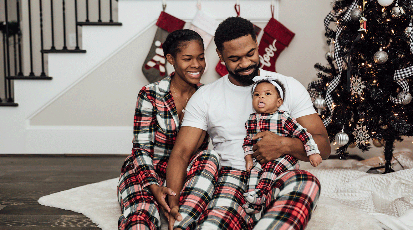 parents with their newborn baby on christmas