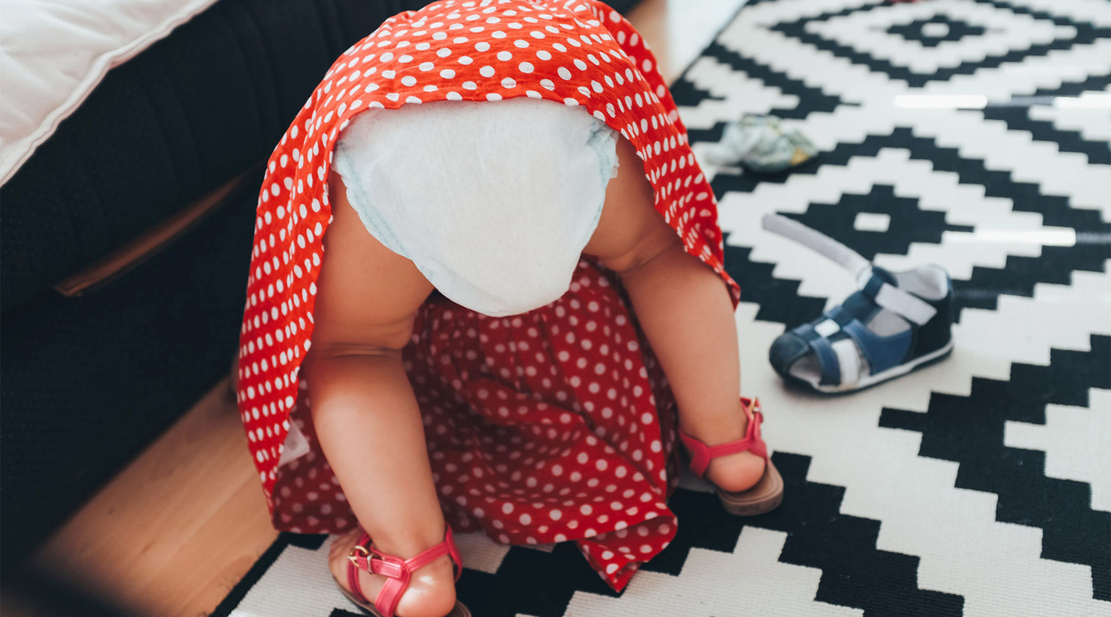toddler girl wearing diaper bent over