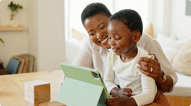 mom and baby looking at ipad at home