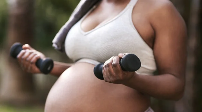 pregnant woman lifting weights for exercise