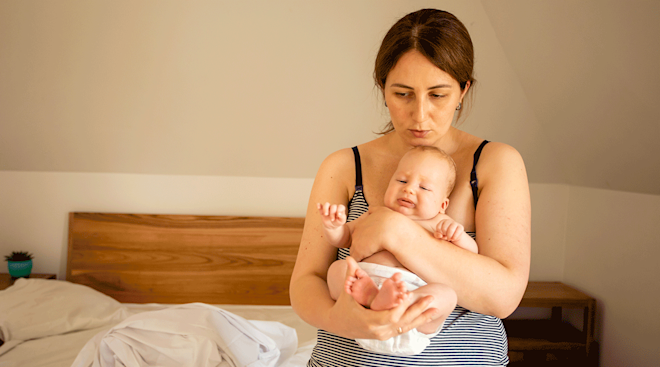 postpartum mom caring for newborn baby at home