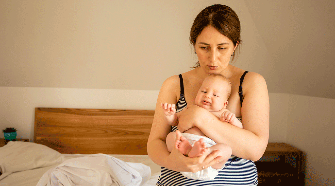 postpartum mom caring for newborn baby at home