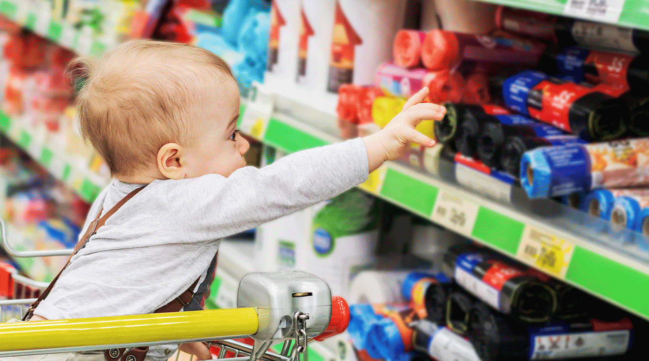 toddler sitting in grocery shopping cart
