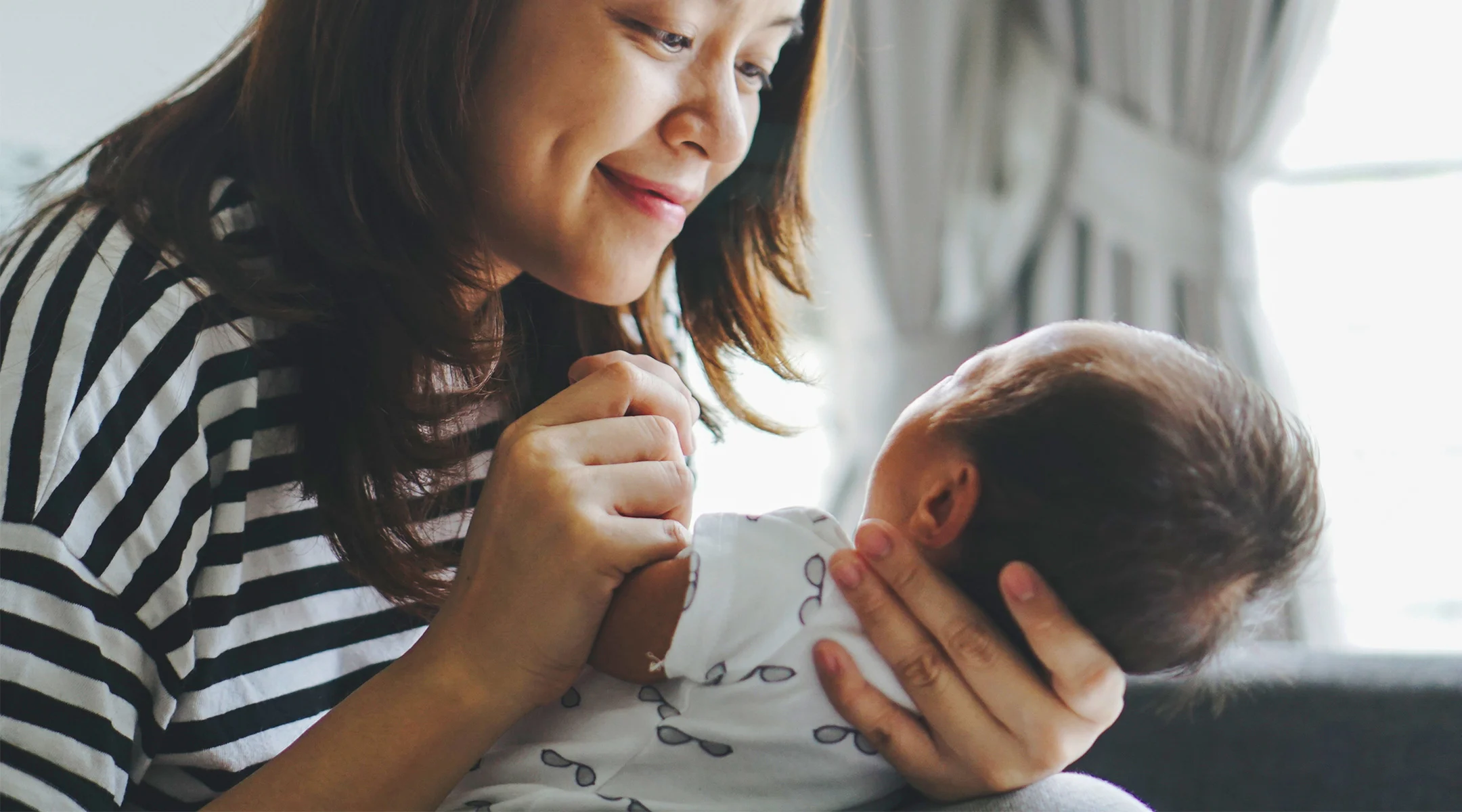 new mom staring lovingly at her new baby