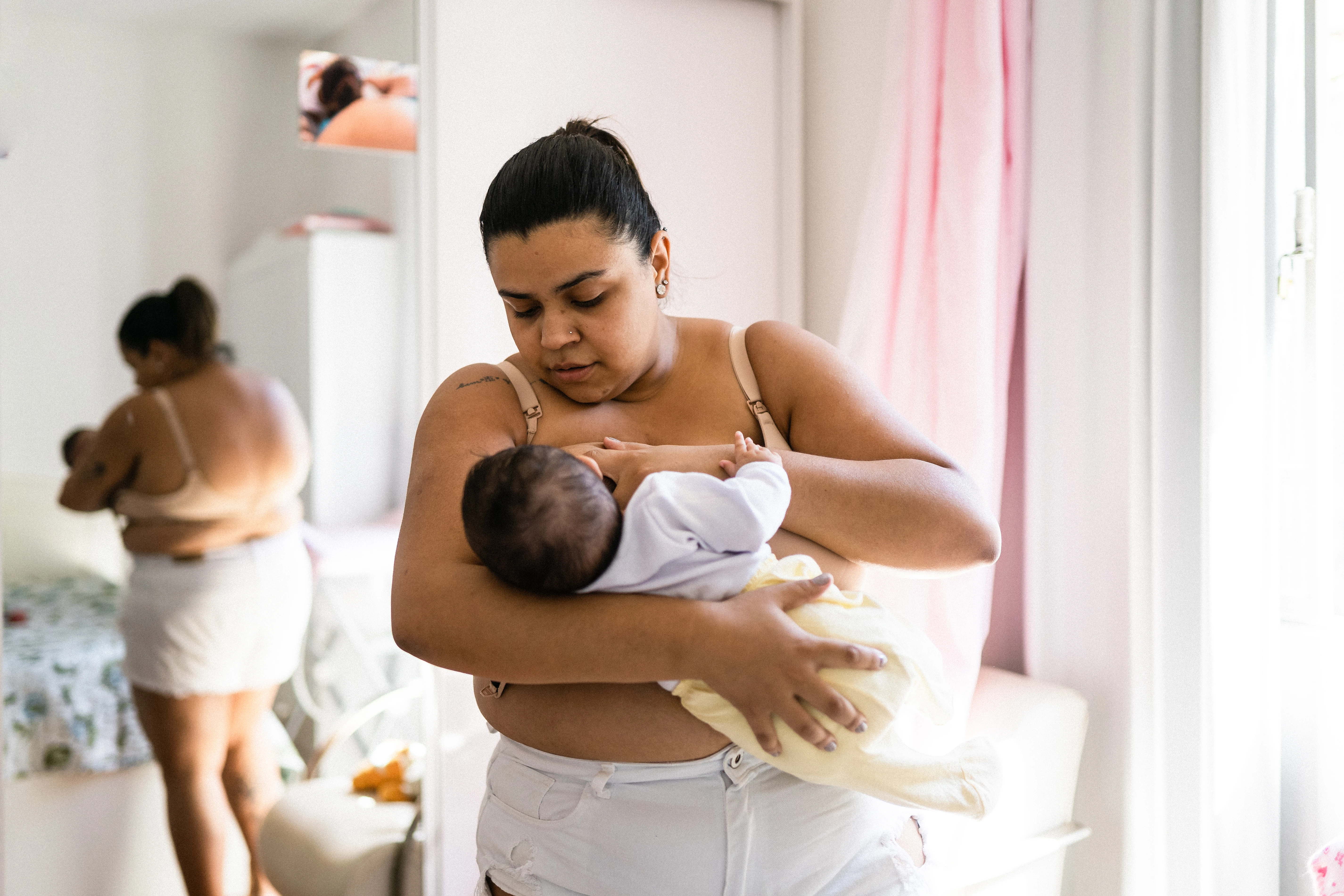 mom breastfeeding her newborn baby