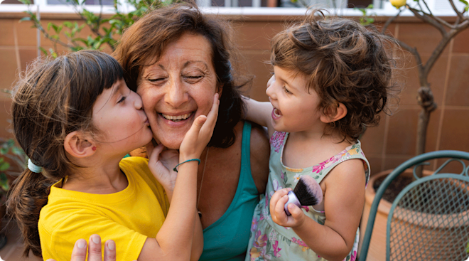 two little girls smiling with grandma