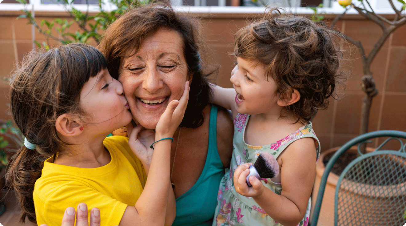 two little girls smiling with grandma