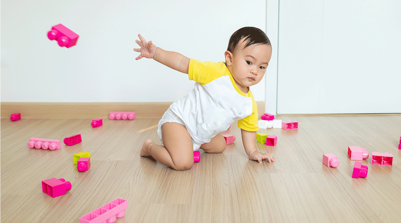 toddler throwing pink block toys