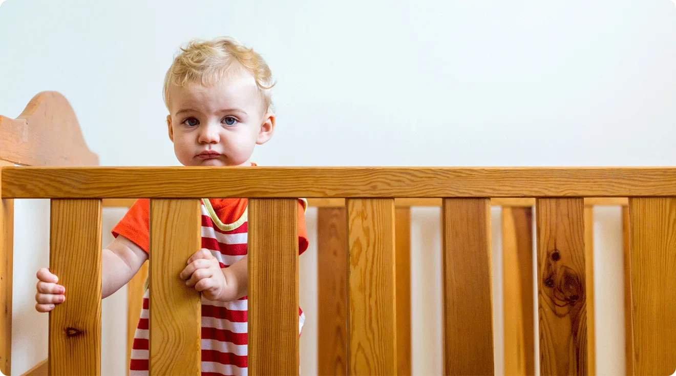 1 year old standing in crib
