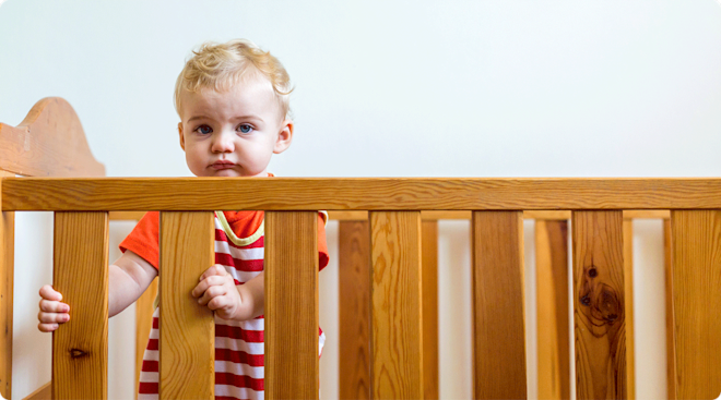 1 year old standing in crib