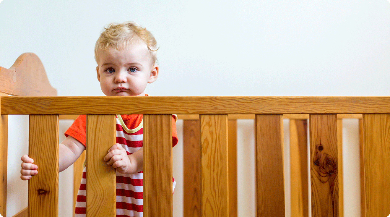 1 year old standing in crib
