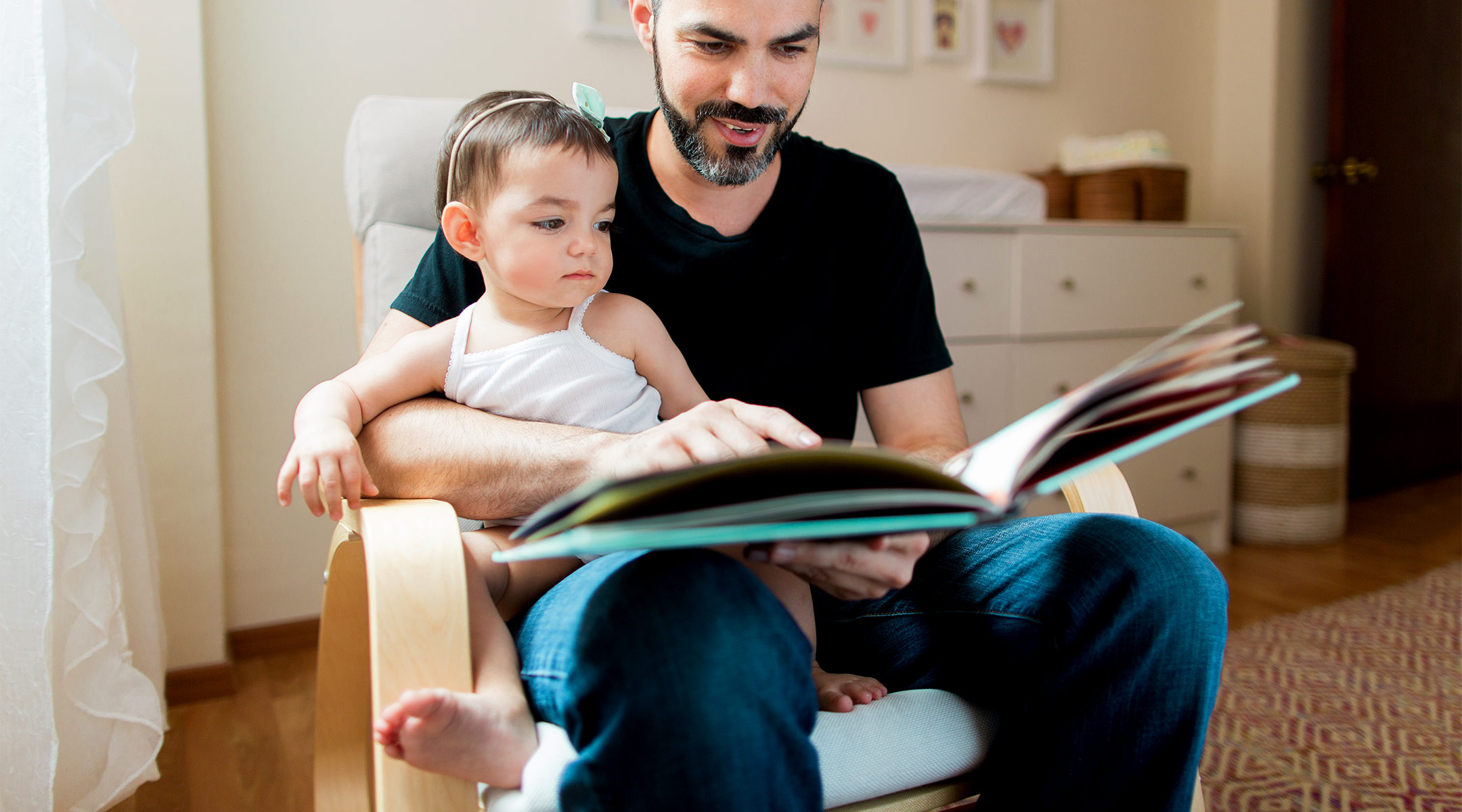 dad reading to his baby girl