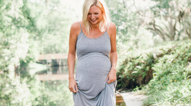 pregnant woman wearing basic maxi dress and laughing outside