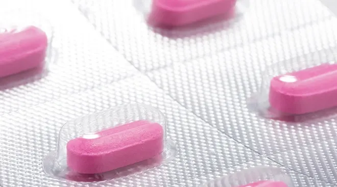 pink benadryl antihistamine pills in plastic packaging