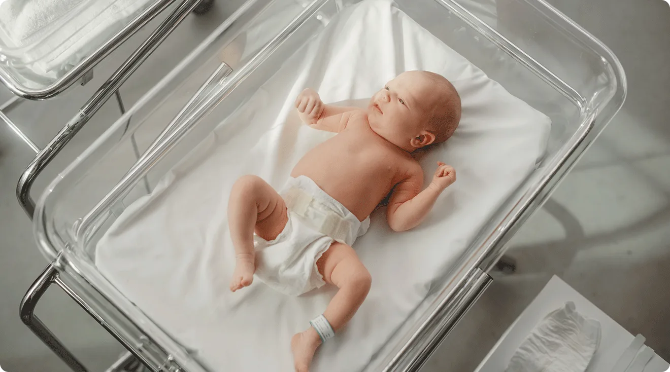 newborn baby in hospital bed after birth