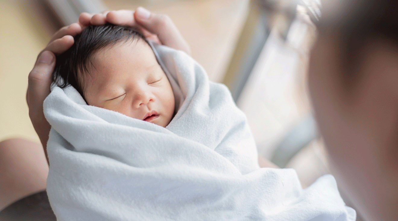 holding newborn baby after birth