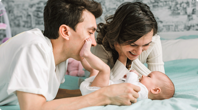 happy mom and dad with baby at home