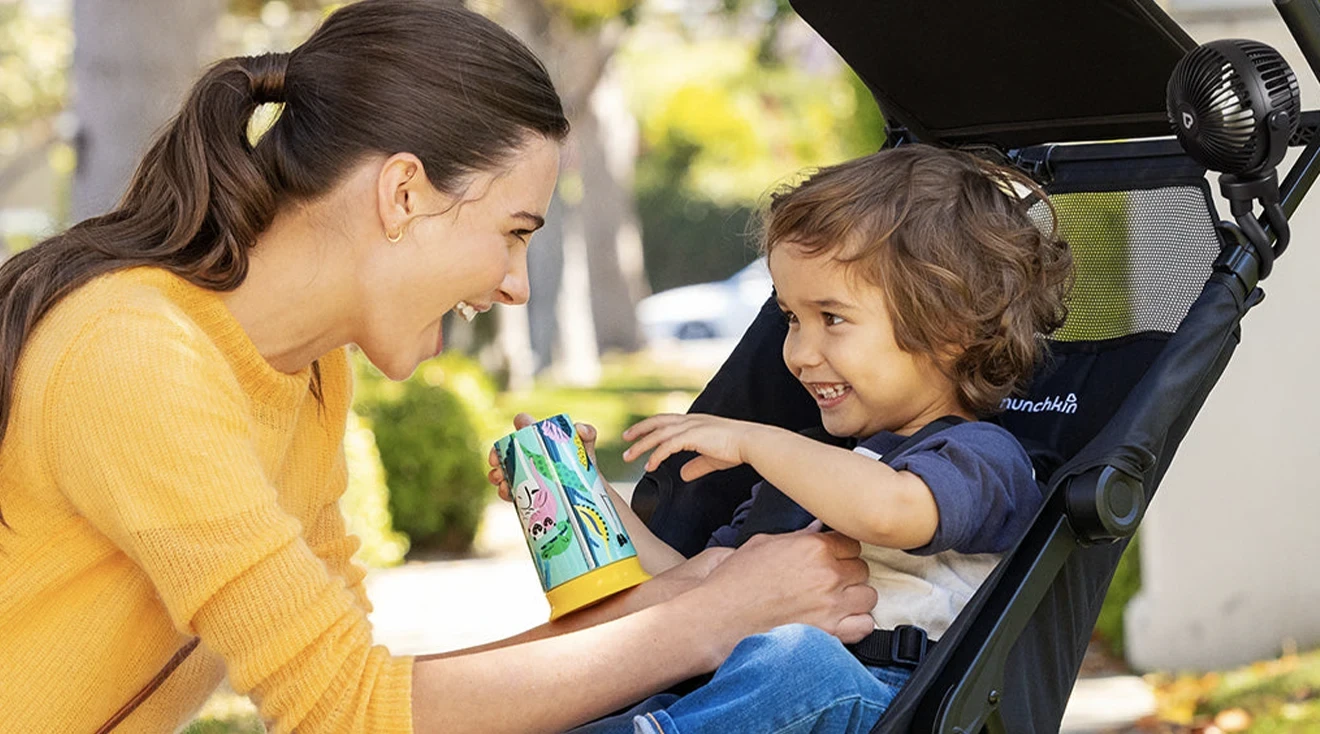 Parent smiling at child in the stroller