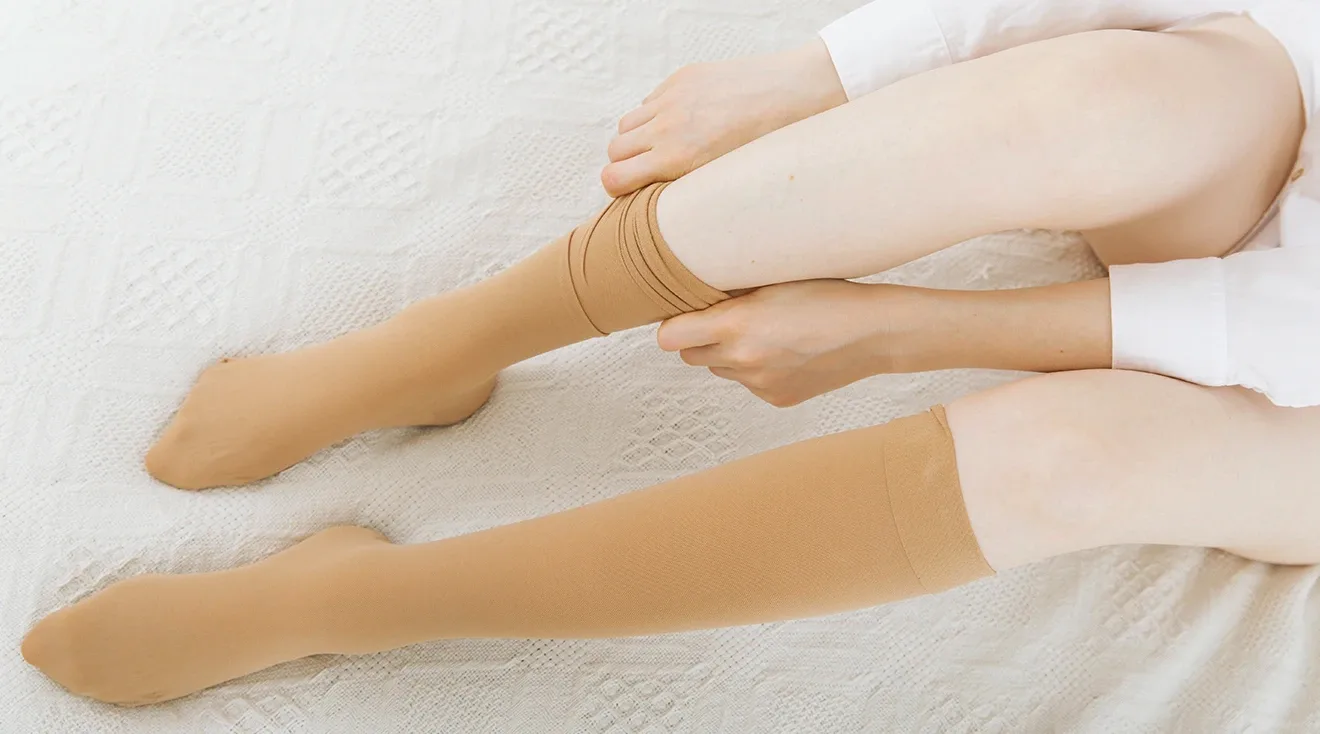 woman putting on compression socks