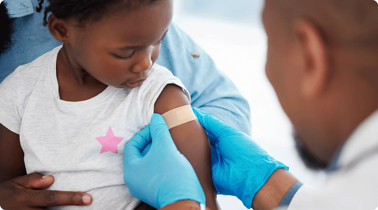 child getting a vaccine from a doctor