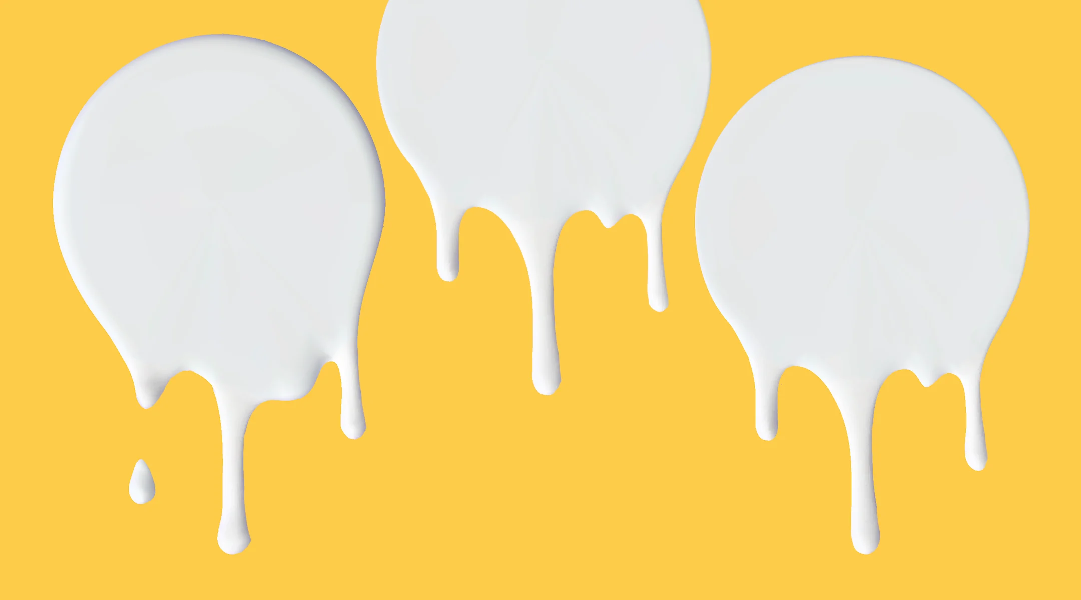 drops of milk on yellow background
