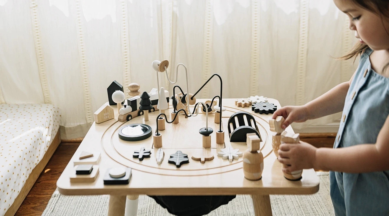 toddler playing with activity center table