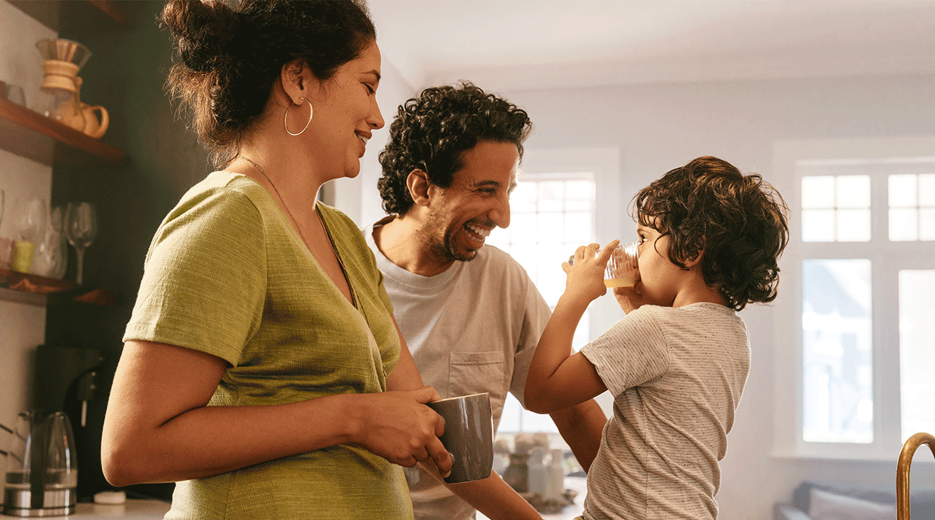 mom and dad in kitchen with their toddler son