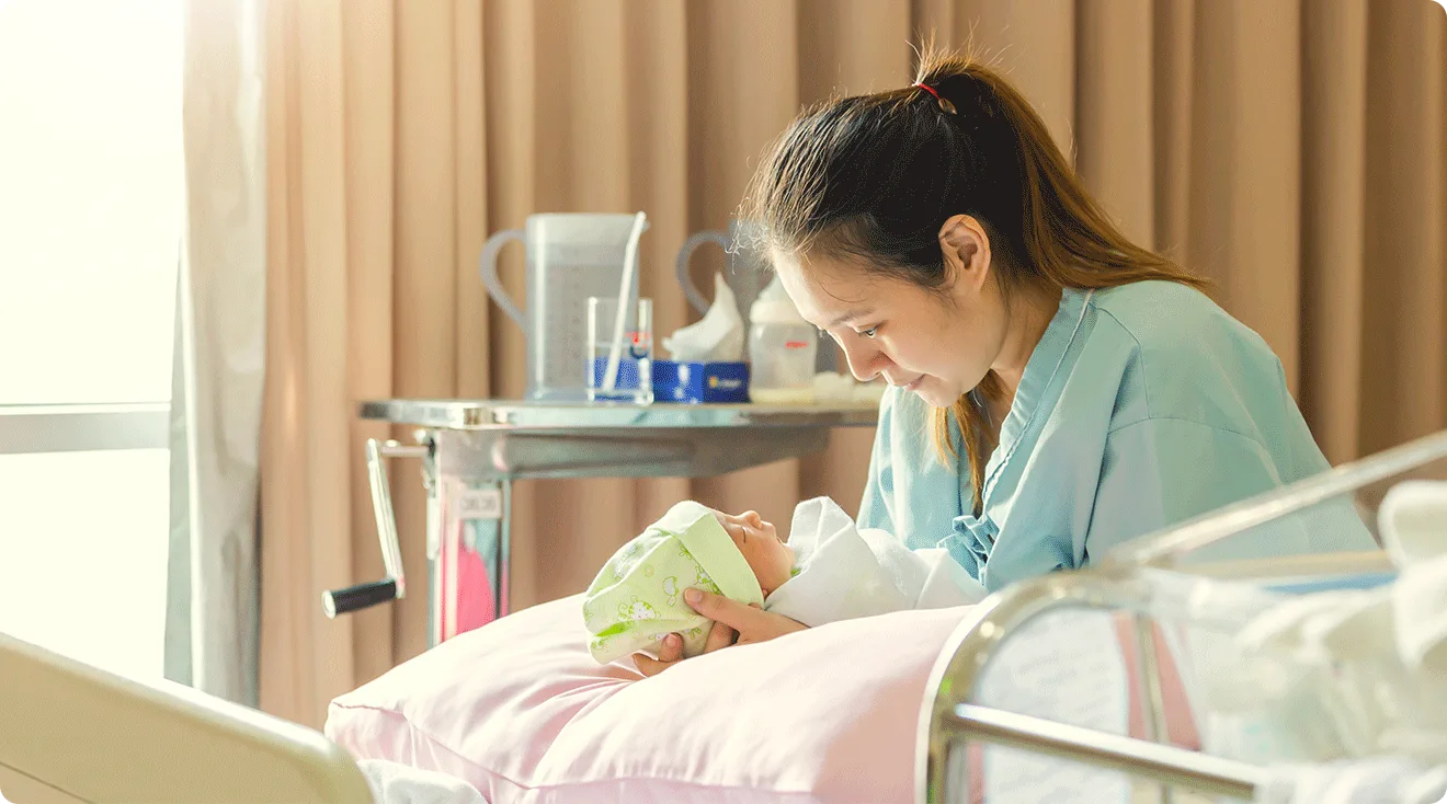 mom and newborn baby in hospital bed