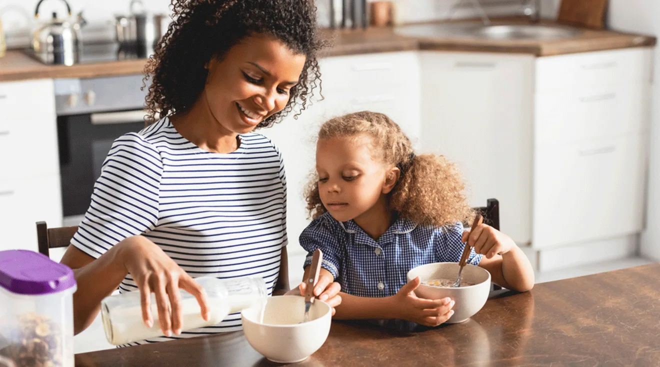 mother and daughter enjoying cereal breakfast at home