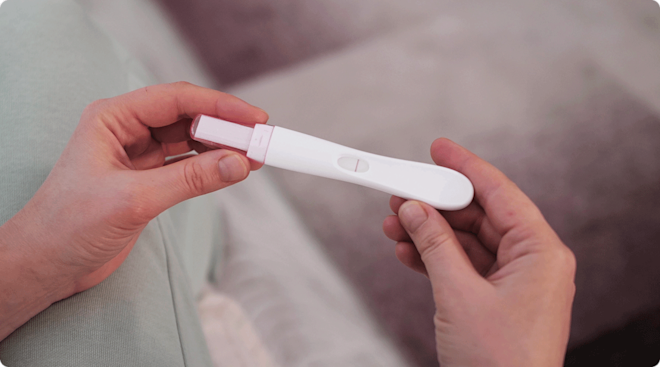 woman holding negative pregnancy test