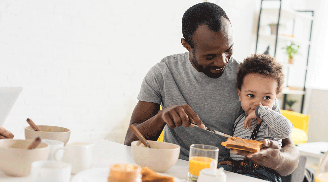 dad making peanut butter sandwich with baby at home