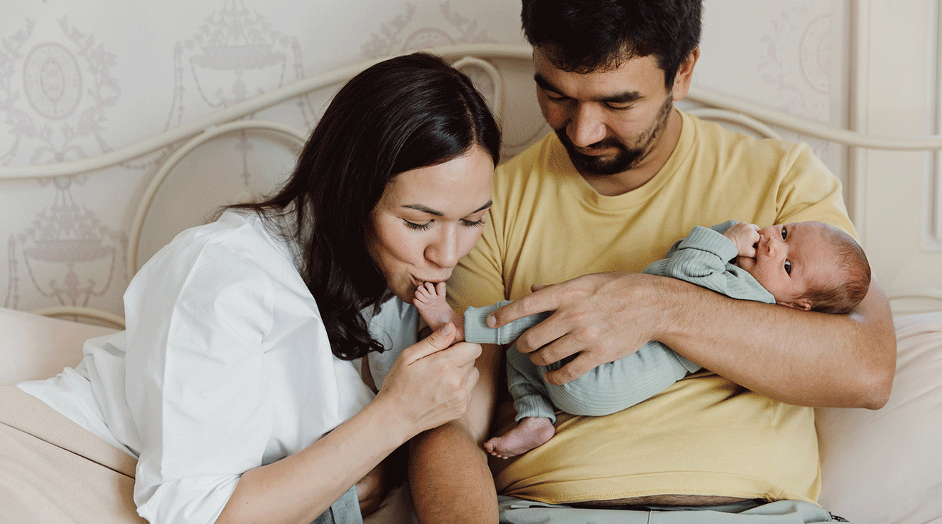 mom and dad at home with their newborn baby