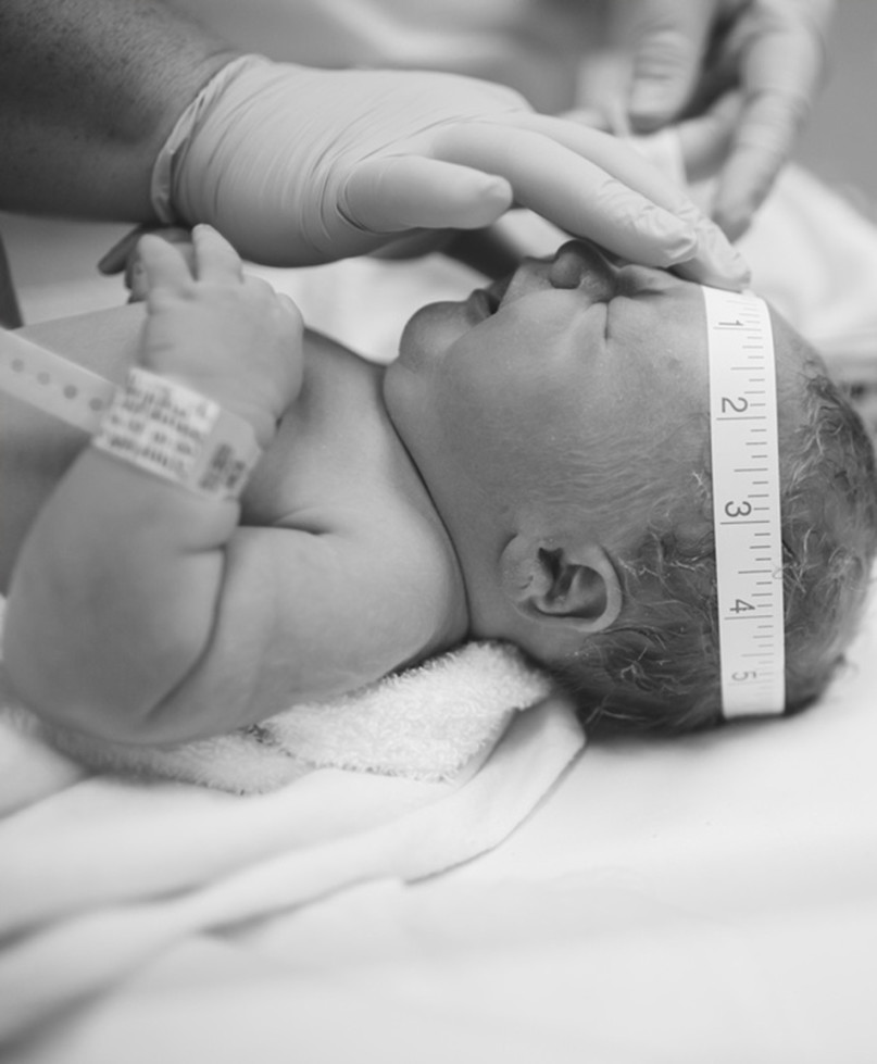 Nurse Measures Babys Head Circumference Stock Photo - Download