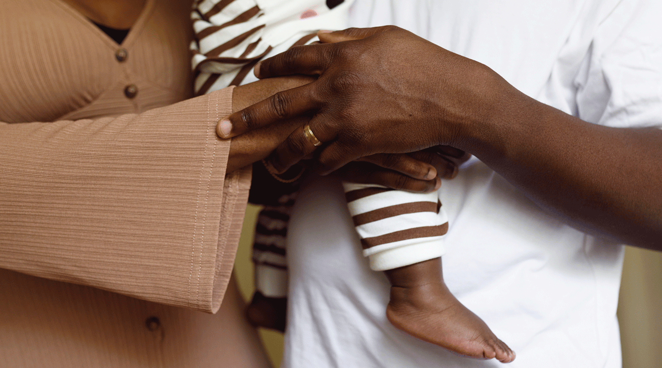 mom and dad holding baby