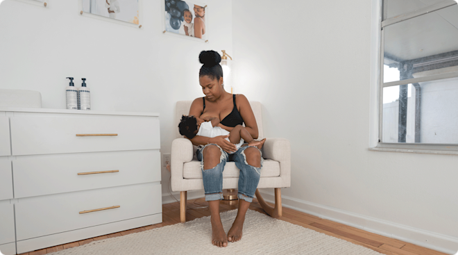 mom breastfeeding baby in rocking chair in baby nursery at home