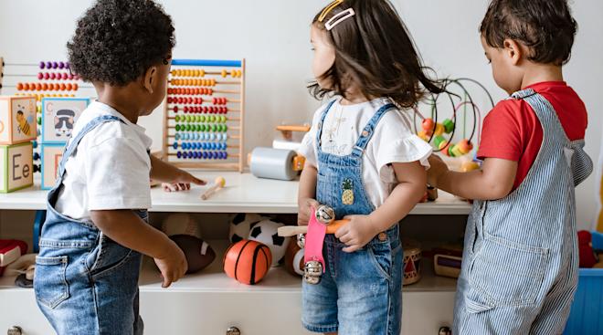pre-school age children playing together in classroom