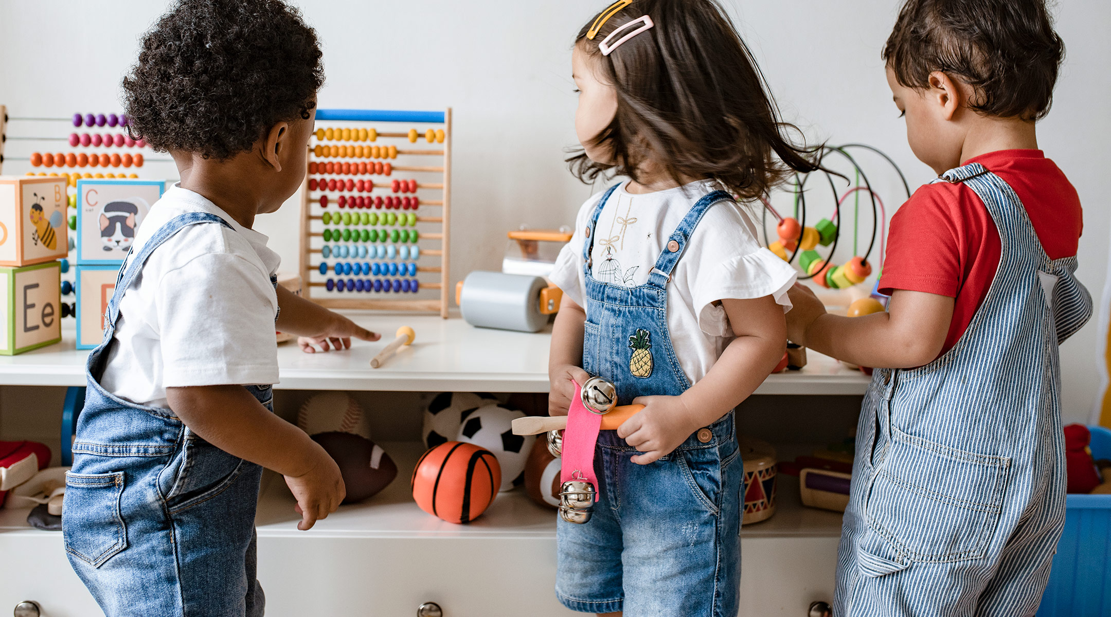 pre-school age children playing together in classroom