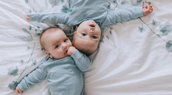 twins laying down and looking curious
