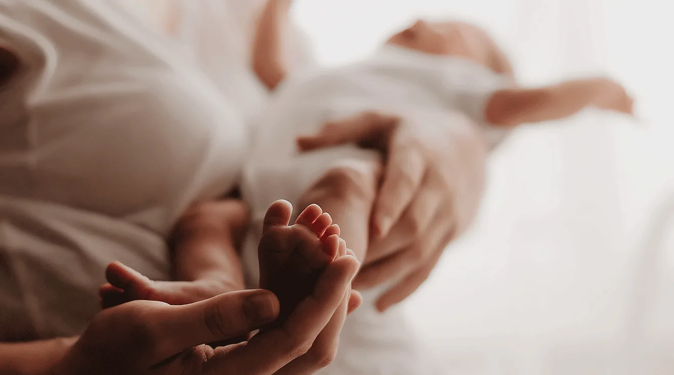 mother massaging baby feet