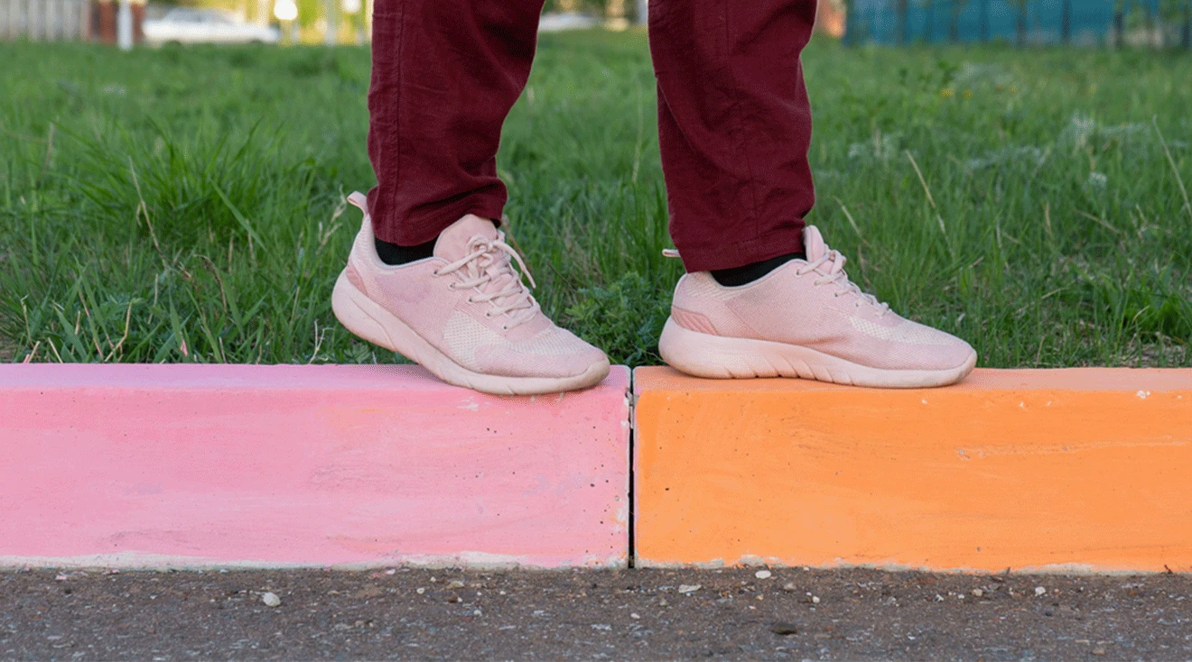 woman's feet walking on curb