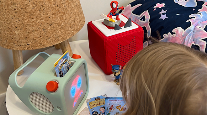 toddler playing with tonie and yoto toys