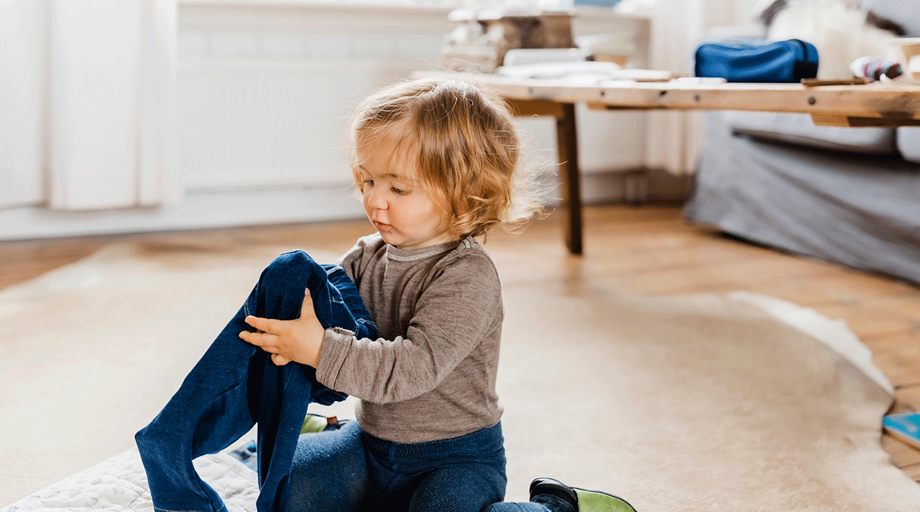 toddler folding clothes