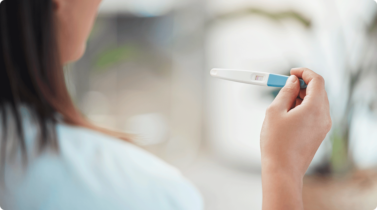 woman looking at pregnancy test