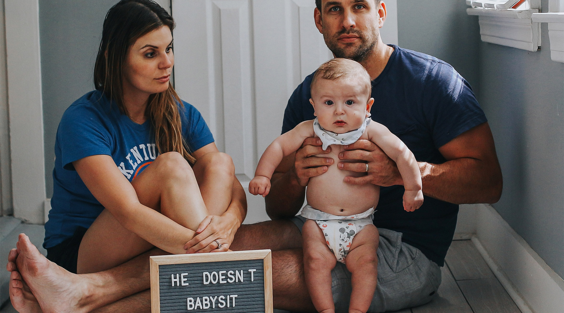 mom poses with her husband and baby makes point that her husband is not her babysitter