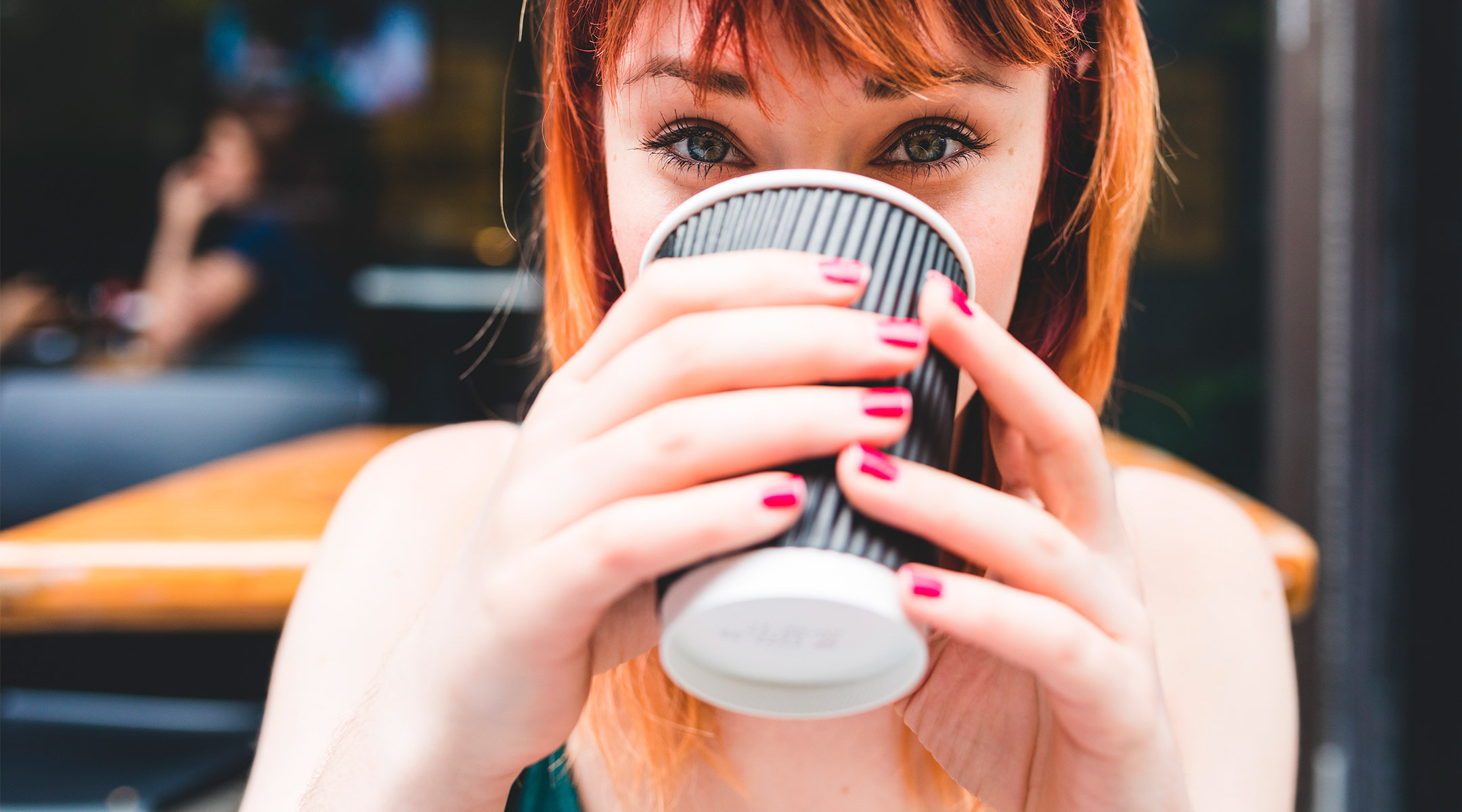 happy young woman drinking to go  coffee