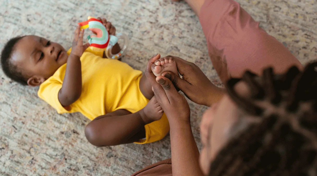 mother massaging baby's feet