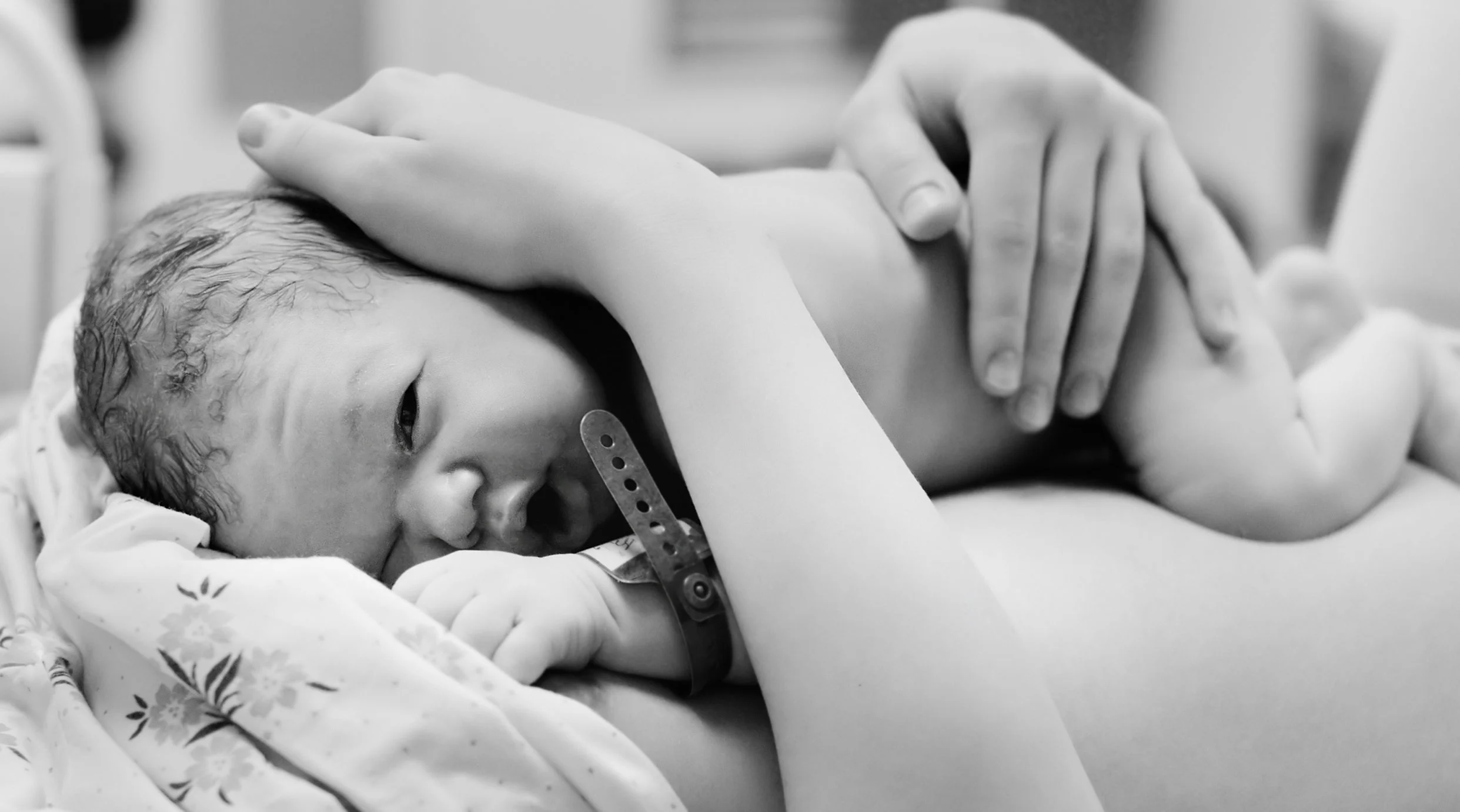 mom holds newborn baby after birth