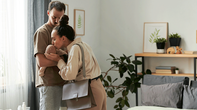 mother kissing baby before leaving for work